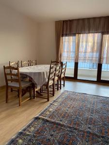a dining room with a table and chairs and a rug at Apartment at a Resort by the Black Sea in Sakarya