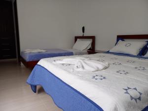 Postel nebo postele na pokoji v ubytování Hotel Prestigio JC