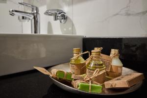a bowl with two bottles of essential oils in a bathroom at White Palace Old City Boutique Hotel in Istanbul