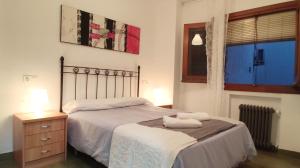 a bedroom with a bed with two towels on it at Apartamento En Centro Historico in Granada