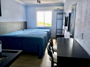 Cama ou camas em um quarto em Residencial Gralha Azul