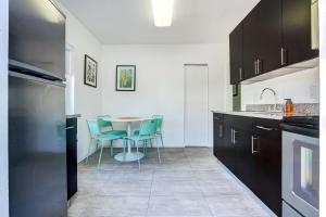 a kitchen with a table and chairs in it at Cottages El Portal in Miami +25 photos