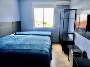 Cama ou camas em um quarto em Residencial Gralha Azul