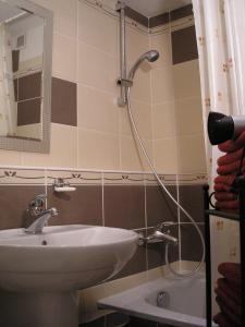 a bathroom with a sink and a shower at Apartment Riverside - River View in Bratislava