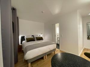Postel nebo postele na pokoji v ubytování Appart Hôtel Victoria