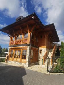 a large wooden house with a roof at Vila Engelshof - Zlatibor in Zlatibor