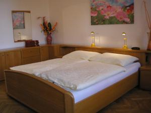 a bed in a room with two pillows on it at Apartment Riverside - River View in Bratislava