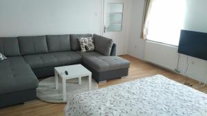 a living room with a couch and a coffee table at FSQH SECRET TOWER in Szeged