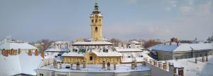 a building with a clock tower with snow on it at FSQH SECRET TOWER in Szeged