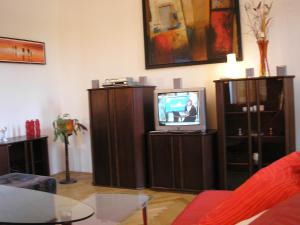 a living room with a tv and some furniture at Apartment Riverside - River View in Bratislava