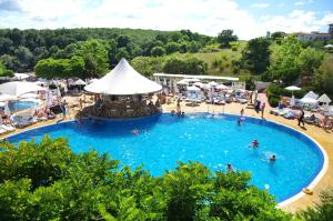a large swimming pool with people in the water at Bella Vista Beach Club - All Inclusive in Sinemorets