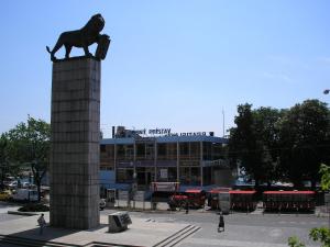 a statue of a lion sitting on top of a monument at Apartment Riverside - River View in Bratislava
