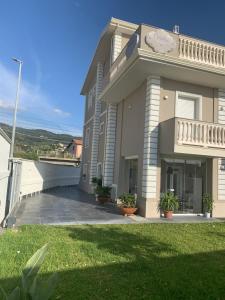 a large building with a lawn in front of it at Crialesi Boutique Rooms in Falerna