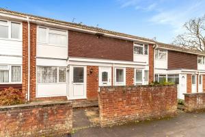 a brick house with white doors and a brick wall at Sawyers Lodge in Burgess Hill