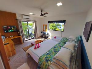 a bedroom with a large bed with red pillows on it at Palms Retreat in Fulhadhoo