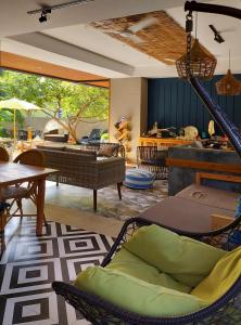 a living room with chairs and a table at Palms Retreat in Fulhadhoo