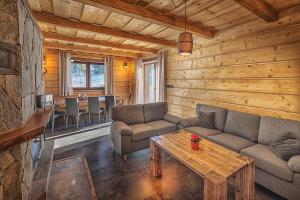 a living room with a couch and a table at Chata Líška JASNA in Liptovský Mikuláš