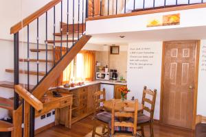 a kitchen with a wooden table and a staircase at Casa San Blas Cusco Exquisite By Xima in Cusco