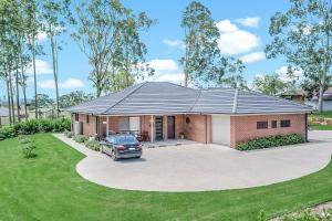 a house with a car parked in front of it at Mala Retreat, Shiraz Suite 5 Star Immaculate and Comfortable in East Maitland