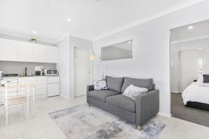 a living room with a couch and a bedroom at Mala Retreat, Shiraz Suite 5 Star Immaculate and Comfortable in East Maitland