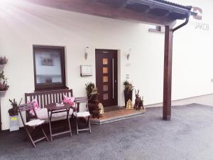 a room with a porch with a table and chairs at Apart Jakob in Schwendau