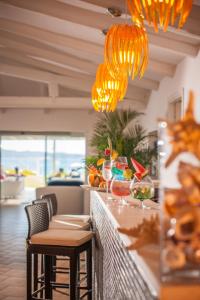 a restaurant with a bar with orange lights at The Pelican Beach Resort & SPA - Adults Only in Olbia