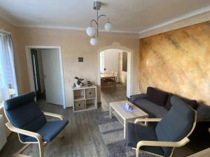 a living room with a couch and chairs and a table at Apartment in Waltershausen in Waltershausen