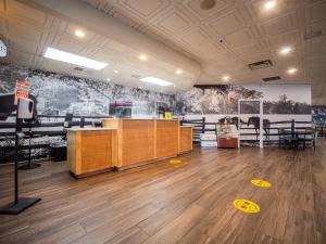 a large room with wooden floors and paintings on the walls at Equus Inn I75 in Ocala