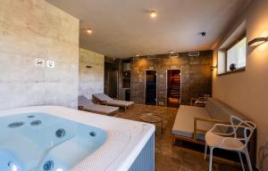 a bathroom with a bath tub in a room at Na Zeleném statku in Rašovice +145 photos