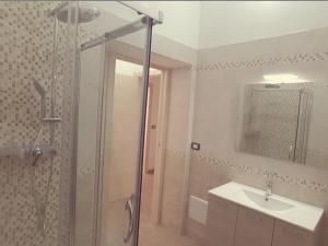 a bathroom with a shower and a sink and a mirror at B & B La Magnolia in Specchiolla