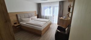 Postel nebo postele na pokoji v ubytování Hotel Anneliese