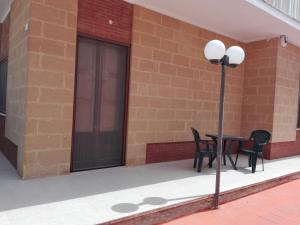 a table and chairs on the side of a building at B & B La Magnolia in Specchiolla
