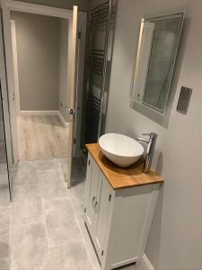 a bathroom with a white sink and a shower at Immaculate 2-Bed Bungalow in Snettisham in Snettisham