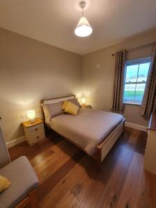 a bedroom with a bed and a window at Claragh Cottage in Cavan
