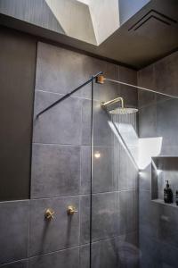 a shower with a glass door in a bathroom at Raffah House in Oatlands