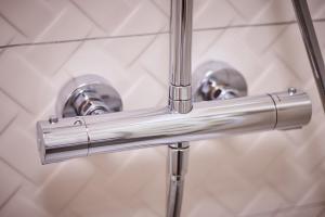 a pair of chrome faucets in a bathroom at STARLIGHT SILVER Szeged - Exclusive in Szeged +30 photos
