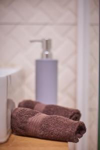 a bathroom with a sink and a soap dispenser at STARLIGHT SILVER Szeged - Exclusive in Szeged