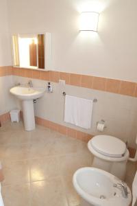 a bathroom with a toilet and a sink at Baglio Bellavista in Torre Nubia +61 photos