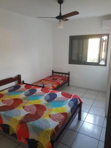 a bedroom with two beds and a ceiling fan at APARTAMENTOS EM TORRES in Torres