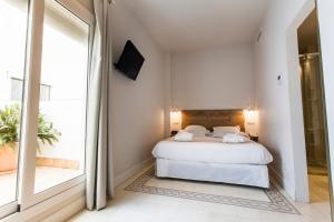 Łóżko lub łóżka w pokoju w obiekcie Hotel Boutique Elvira Plaza