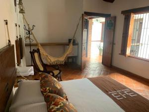um quarto com uma cama e uma rede de descanso em Bohemia Hotel Boutique em Santa Cruz de Mompox