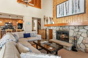 a living room with a couch and a fireplace at 326 Kiva Condo access to Ski in Out in Avon