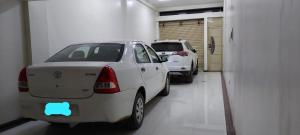 Twee geparkeerde auto's in een garage met een autosticker op de achterkant. bij Departamento KIRI familiar ó empresarial cerca al Aeropuerto de Juliaca- Perú in Juliaca