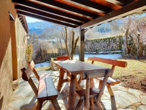 a wooden table and chairs on a patio at Cal Ferrer del Querforadat in Cava
