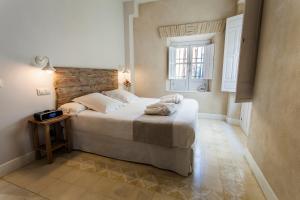 Łóżko lub łóżka w pokoju w obiekcie Hotel Boutique Elvira Plaza