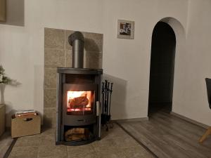 a fireplace in a living room with a stove at diemelseeholiday romantisches Ferienhaus im Sauerland Nähe Willingen Winterberg in Diemelsee +107 photos