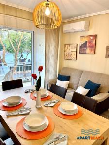 ein Wohnzimmer mit Tisch und Couch in der Unterkunft APARTBEACH SAYONARA 125 Climatizado y Piscina in Salou