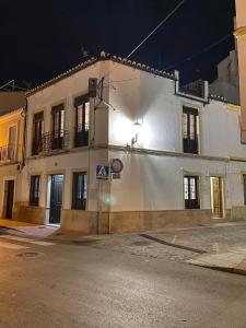 a white building on the side of a street at night at Apartamentos Los Descalzos Ángel With Private Terrace Free Parking in Ronda
