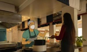 a woman in a kitchen with a chef wearing a mask at NIASHA in Mangalore