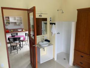 a bathroom with a sink and a kitchen with a table at apartamentos Casa Amarilla in Granada